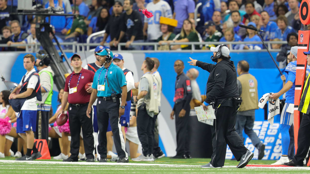 an NFL Official prepares to enter the Instant replay booth during