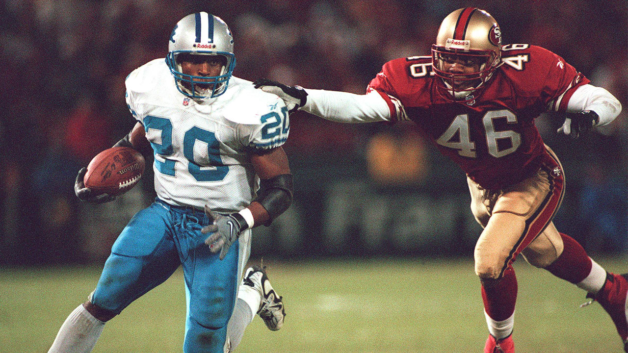 Doak Walker, left, halfback for the Detroit Lions, goes over his