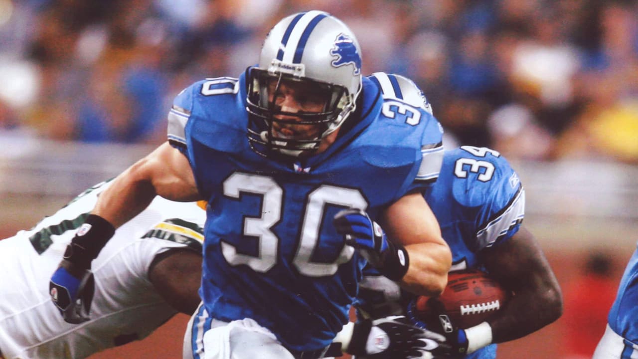 Detroit Lions fullback Cory Schlesinger (30) wears the new Detroit Lions  home uniform while defensive end Kalimba Edwards (98) wears the new road  uniforms in Detroit, Wednesday, April 23, 2003. On the