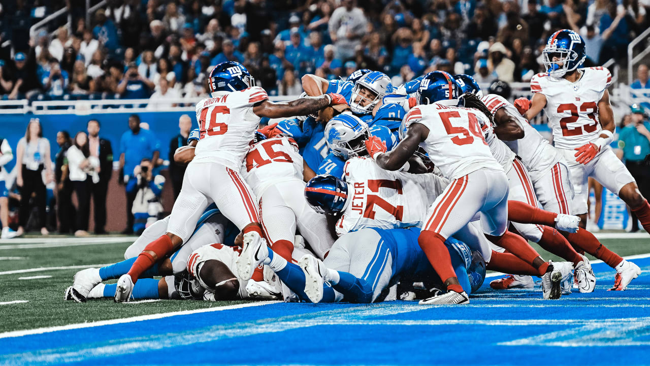 Detroit Lions quarterback Adrian Martinez (18) keeps the ball