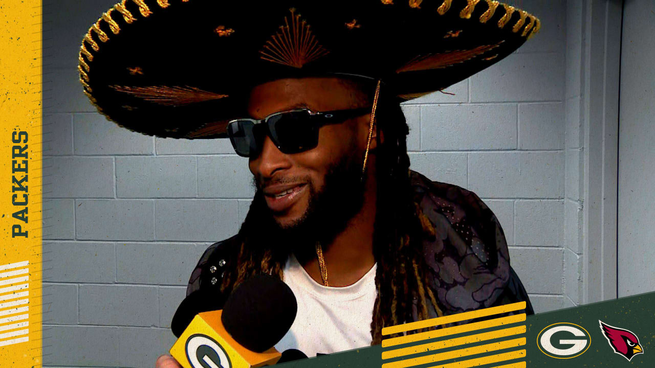 A fan puts his sombrero on Green Bay Packers running back Aaron