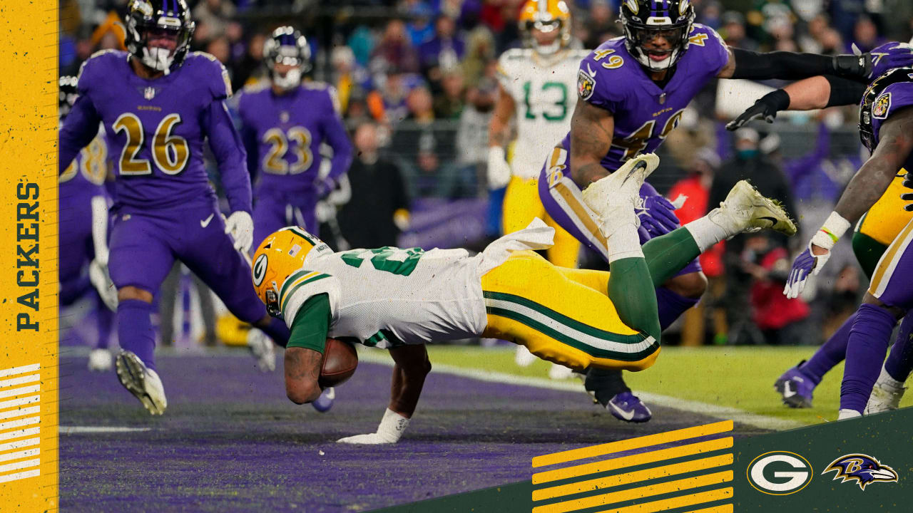 BALTIMORE, MD - DECEMBER 19: Packers running back A.J. Dillon (28) runs the  ball during the Green Bay Packers versus Baltimore Ravens NFL game at M&T  Bank Stadium on December 19, 2021