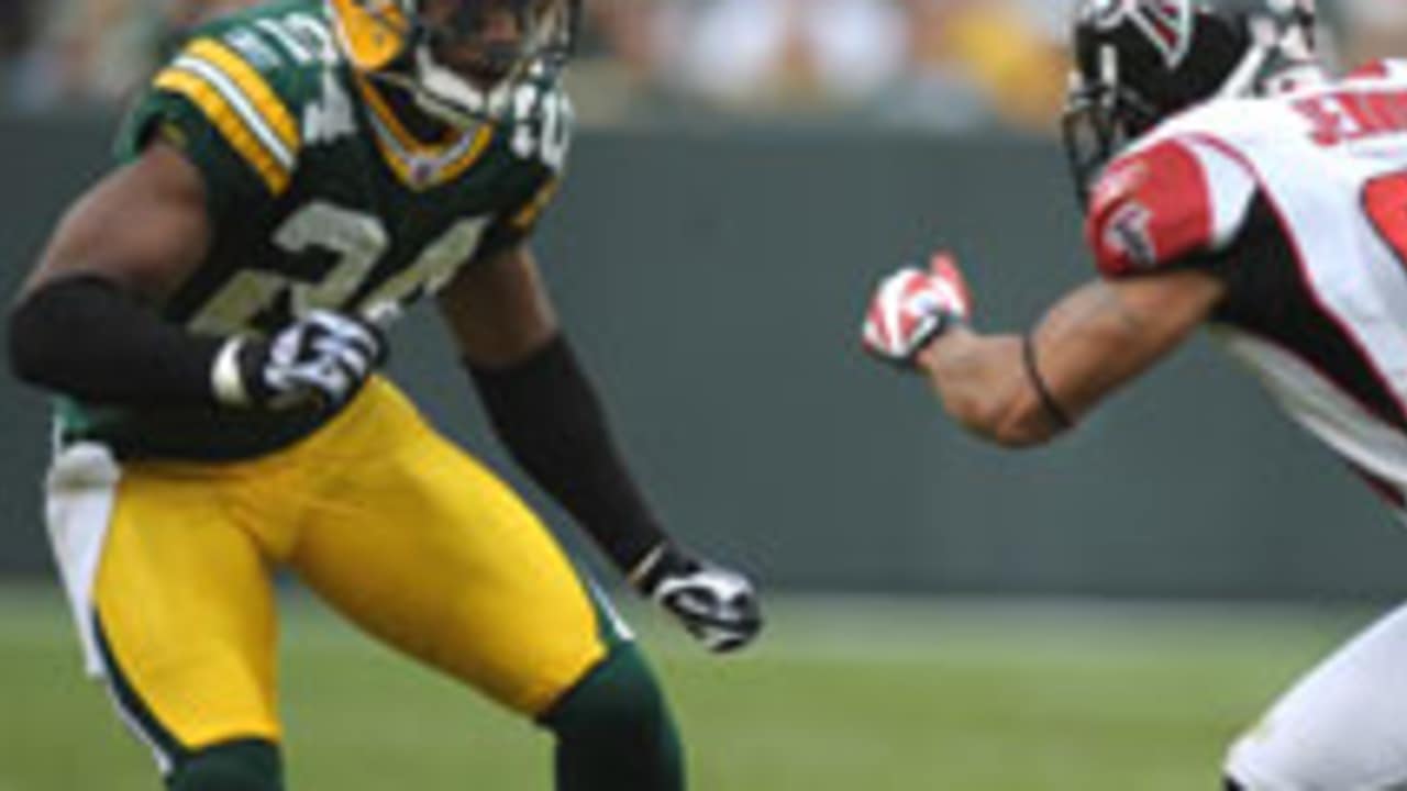 Green Bay Packers special teams player Jarrett Bush (R) trips up