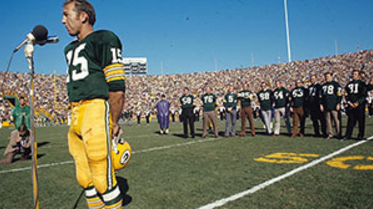 Hall of Fame quarterback Bart Starr carries a Green Bay Packers flag on the  field during introductions before an NFL football game between the Green  Bay Packers and the New Orleans Saints