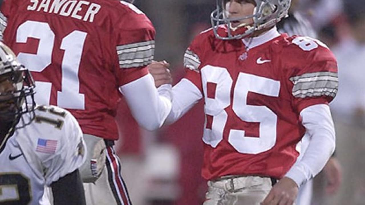 Green Bay Packers holder B.J. Sander watches as kicker Ryan