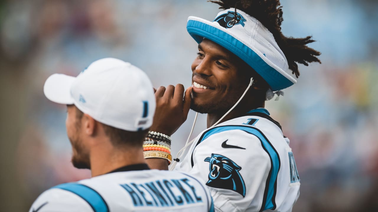 Cam Newton rocking custom bucket hat on sideline.