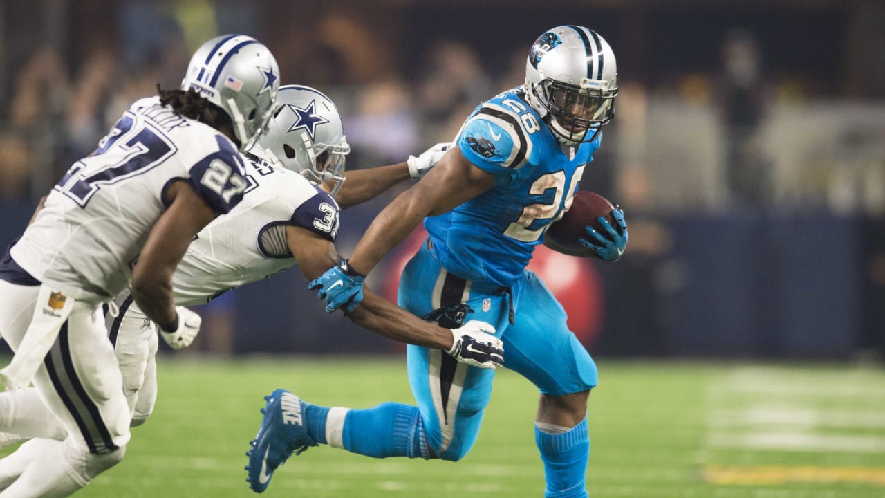 Carolina Panther running back Anthony Johnson (23), runs the ball as Dallas  Cowboy's Shante Carver (96), and Panther Howard Griffith (30) look on  during the third quarter of te NFC Divisional Playoff