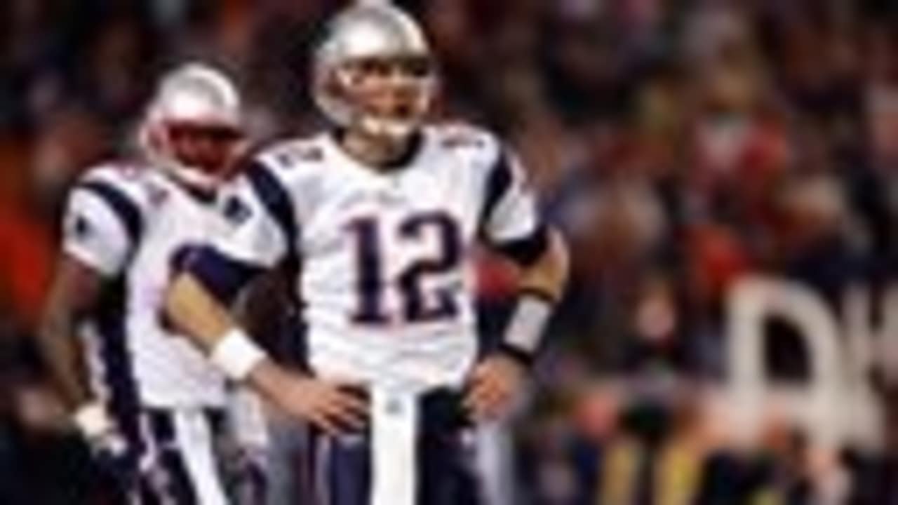 New England Patriots quarterback Tom Brady (12) sails after being hit by  Denver Broncos cornerback Aqib Talib on a first down run in the second  quarter during the AFC Championship game at