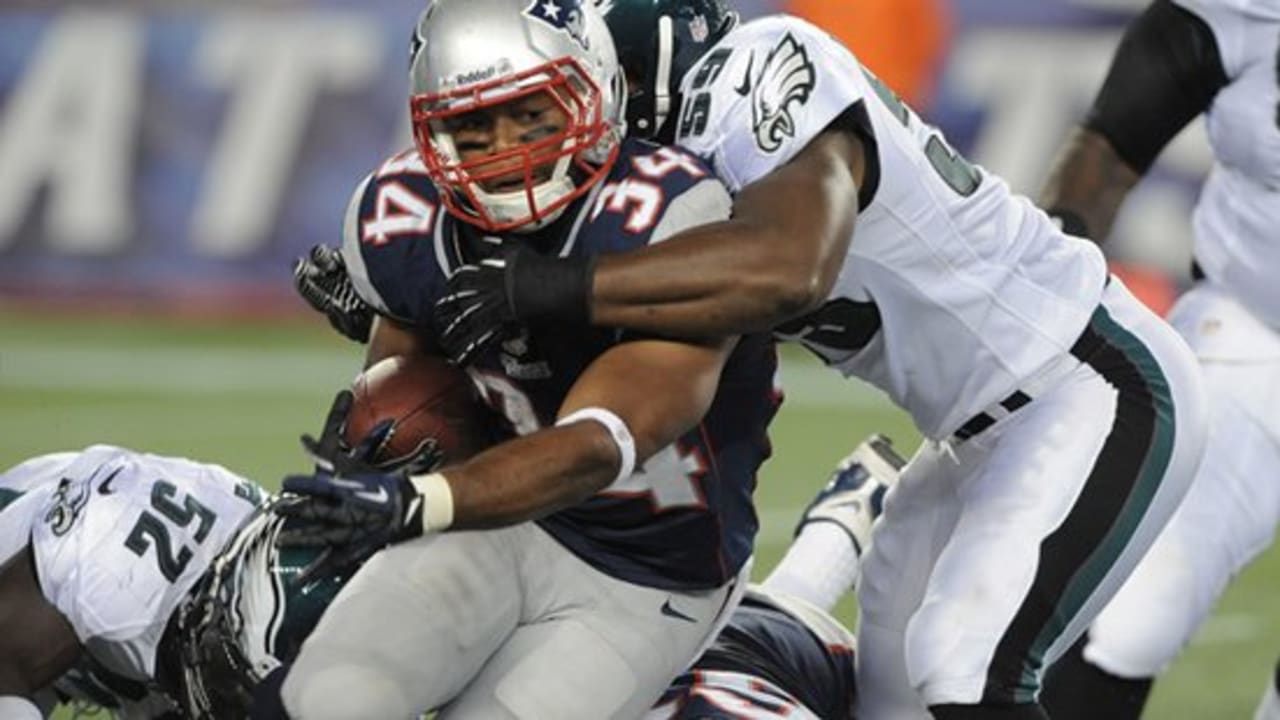 Warrick Dunn of the Atlanta Falcons runs out of the tackle of