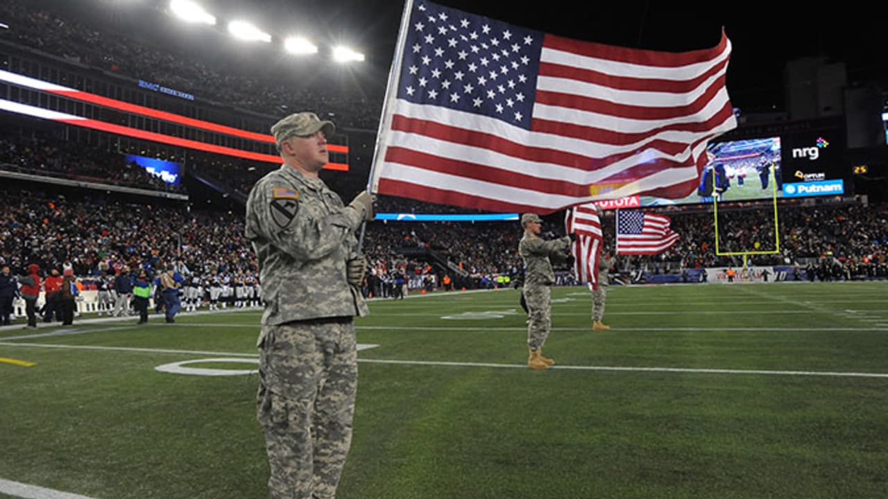 Military personnel carry the colors before the start of an NFL football  game between the Cincinnati Bengals and the Carolina Panthers during the  NFL Salute to Service, Sunday, Nov. 6, 2022, in