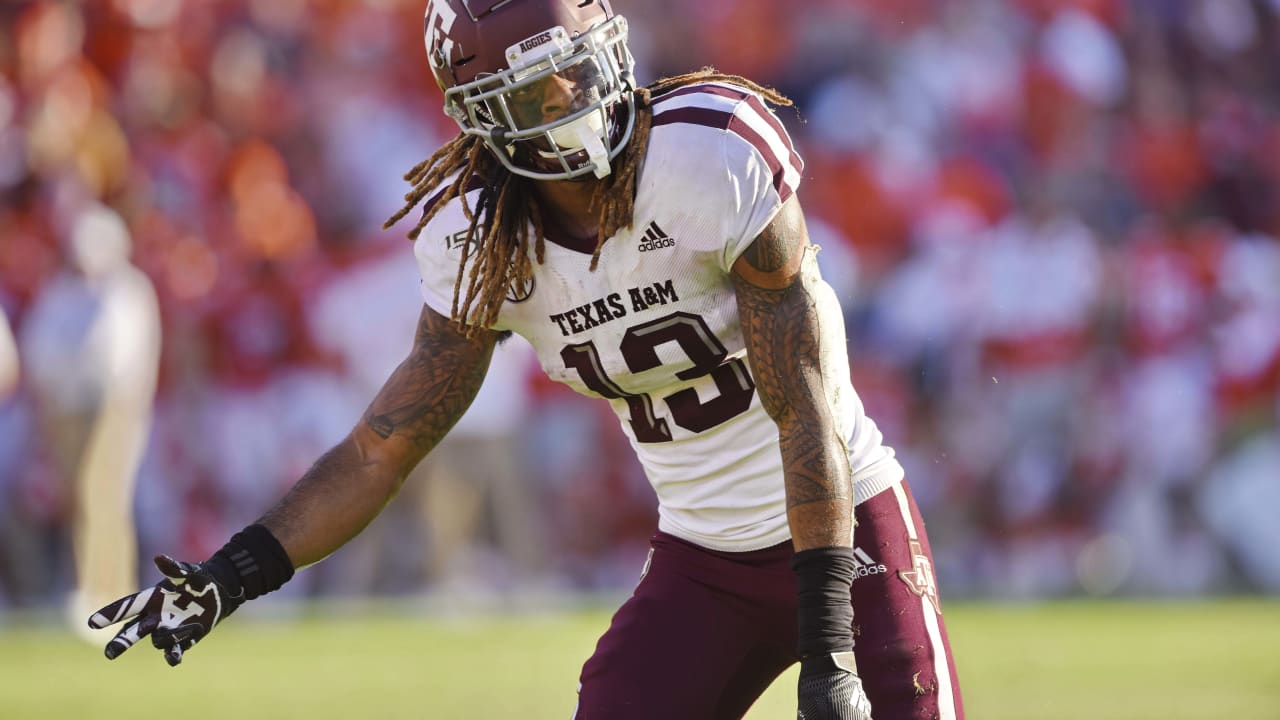 Texas A&M's Kendrick Rogers, top, is tackled by Clemson's Derion