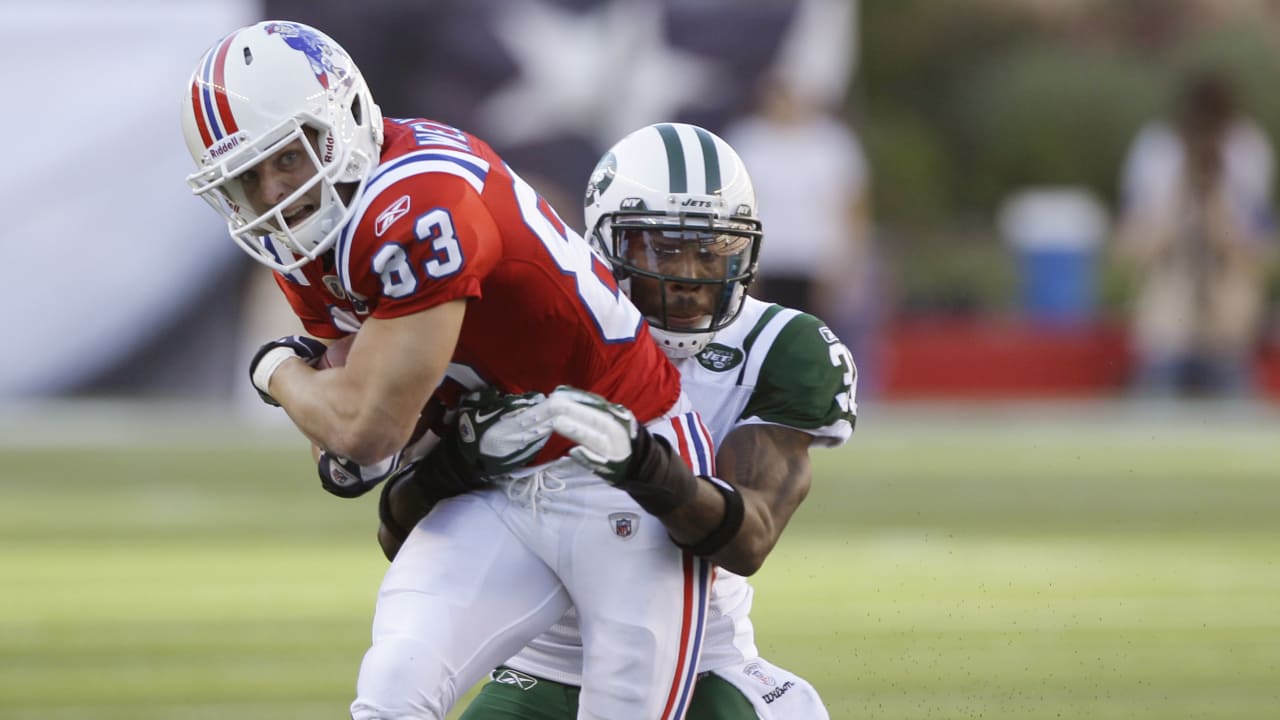 New England Patriots' Aaron Hernandez (81) is tackled by New York Jets'  Kyle Wilson (20) and Jim Leonhard (36) during the third quarter of an NFL  football game Sunday, Nov. 13, 2011