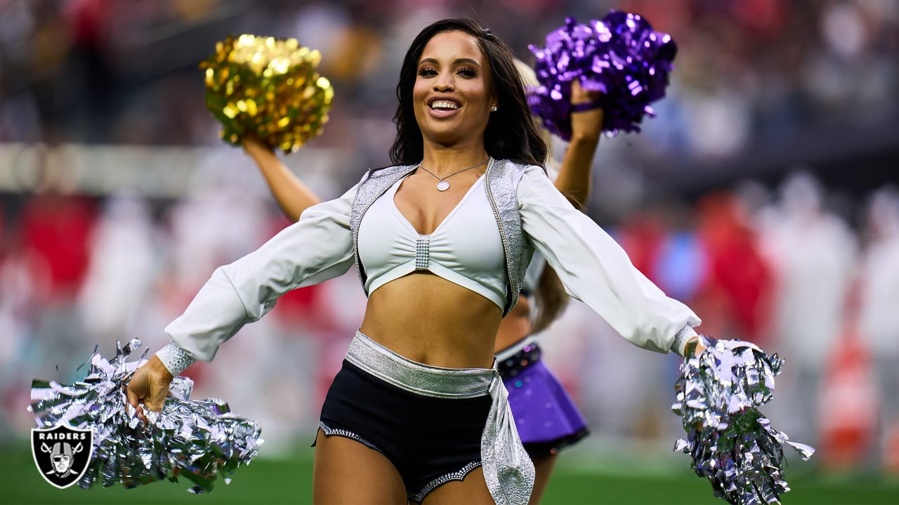 Professional young women cheerleaders in the black-white uniform