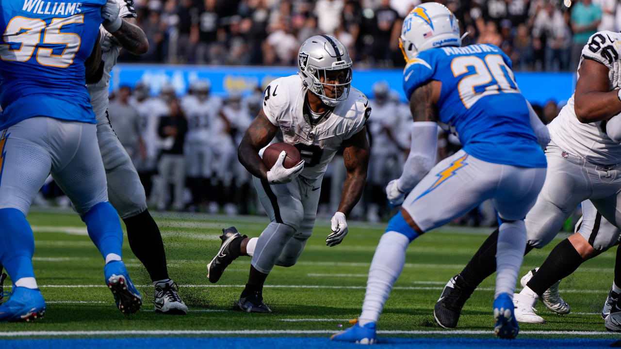 Las Vegas Raiders running back Josh Jacobs (28) gains yards on a run during  an NFL football game against the Los Angeles Chargers, Sunday, September  11, 2022 in Inglewood, Calif. The Chargers