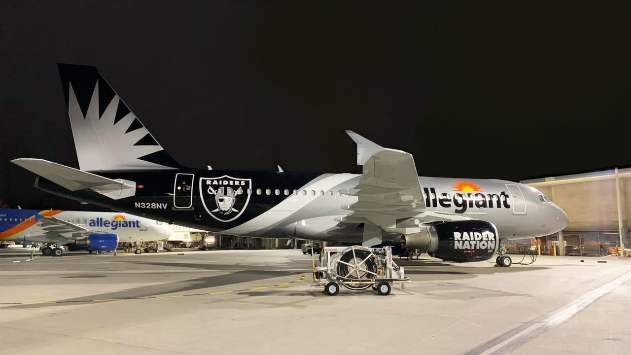 A man poses inside the Raider Image team store at Allegiant