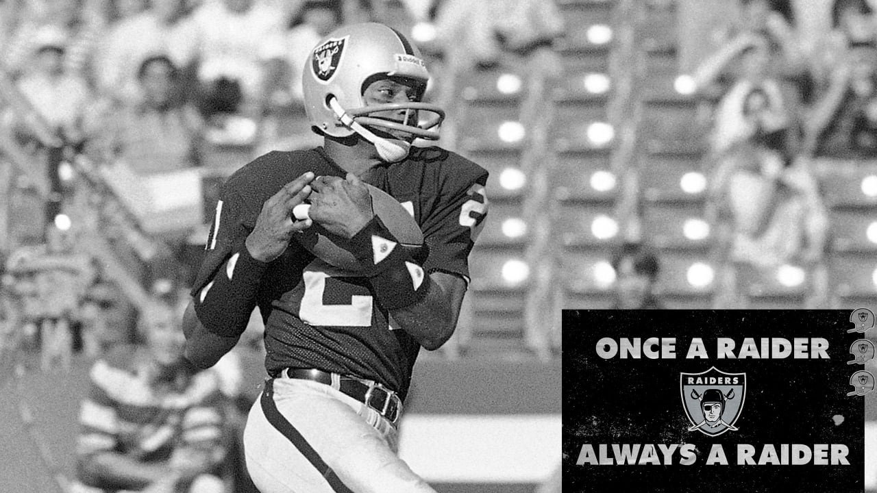 Oakland Raiders quarterback Jim Plunkett (16) prepares to throw the ball in  a game against the …