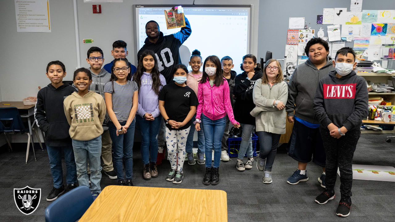 Las Vegas Raiders players lead elementary school students at football camp  in advance of Silver & Black Flag League kickoff