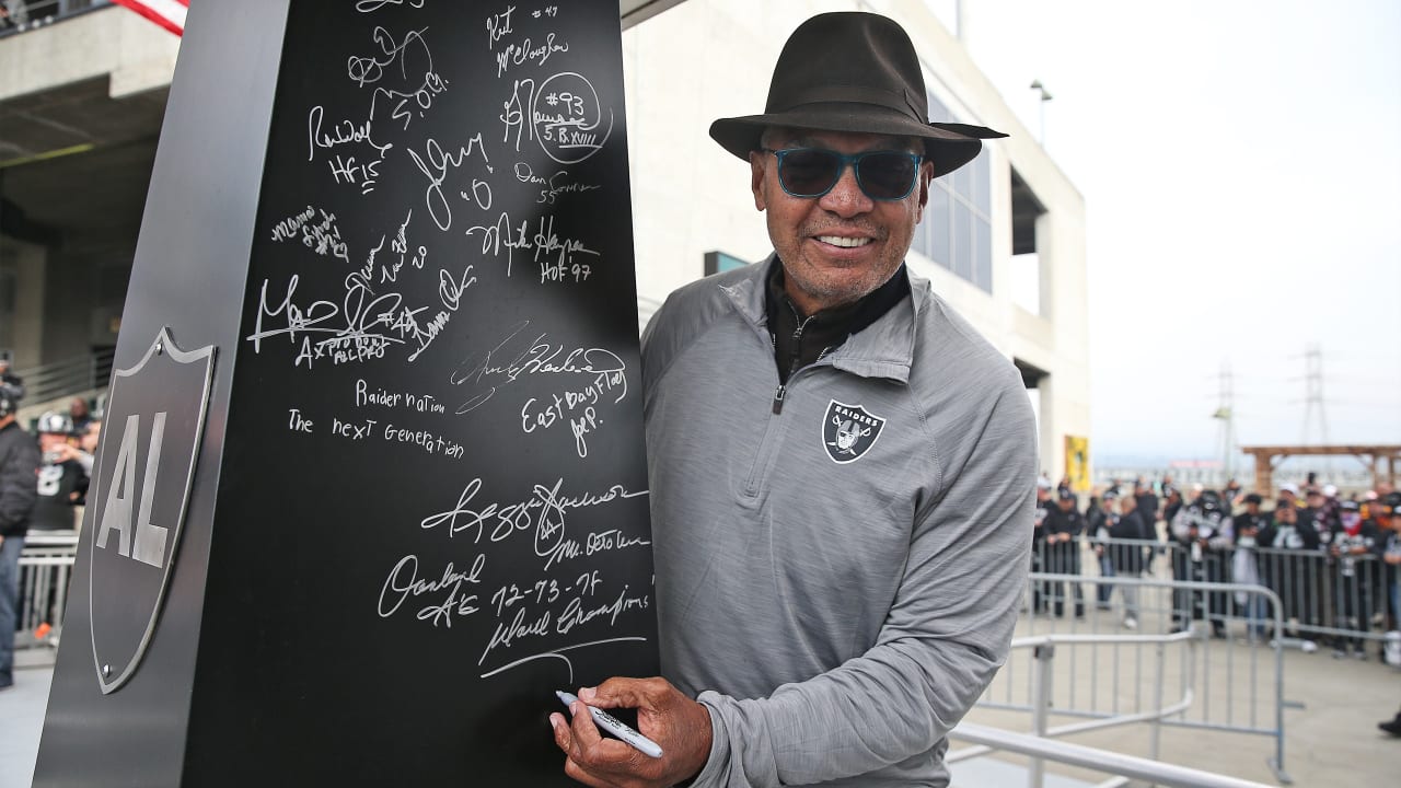 Pro Baseball Hall of Famer Reggie Jackson lit the Al Davis 