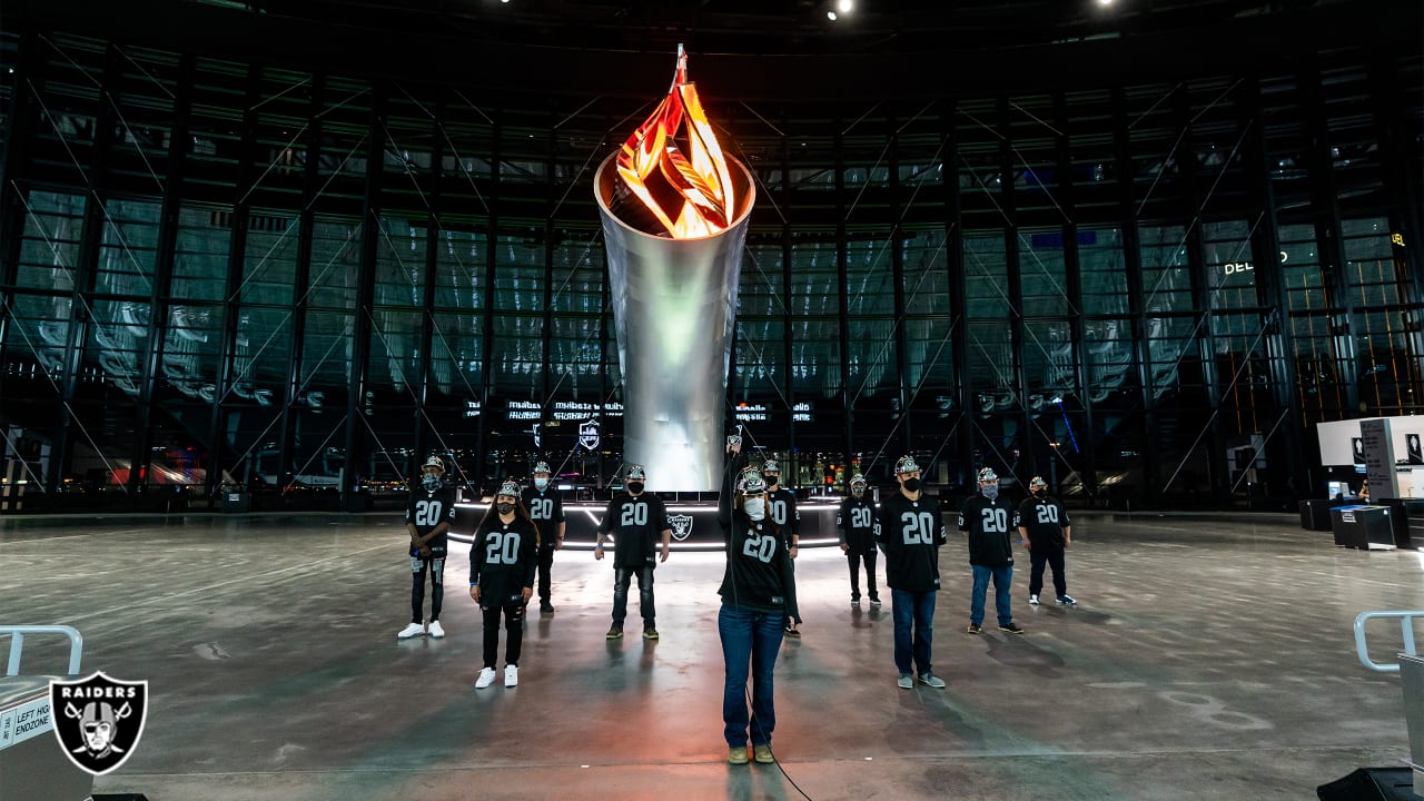 Allegiant Stadium construction workers light the Torch in ...