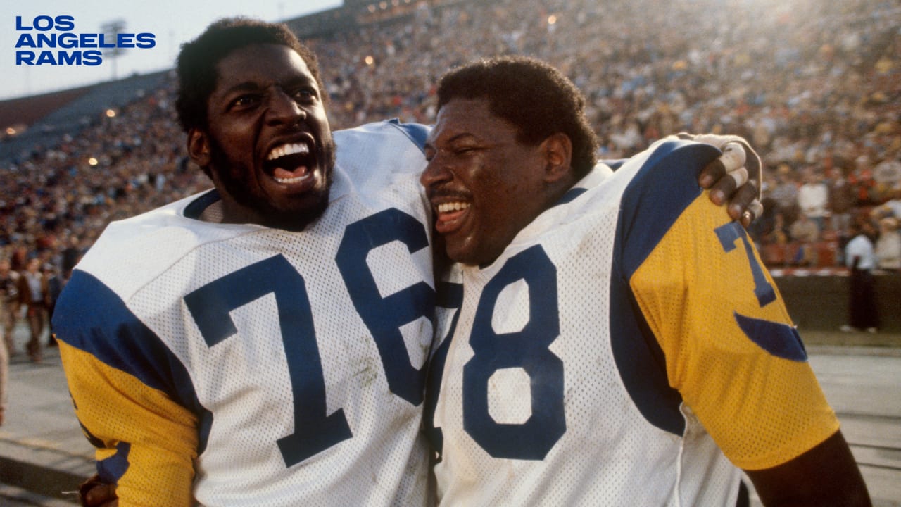 Workers removing Rams banners from the Edward Jones Dome