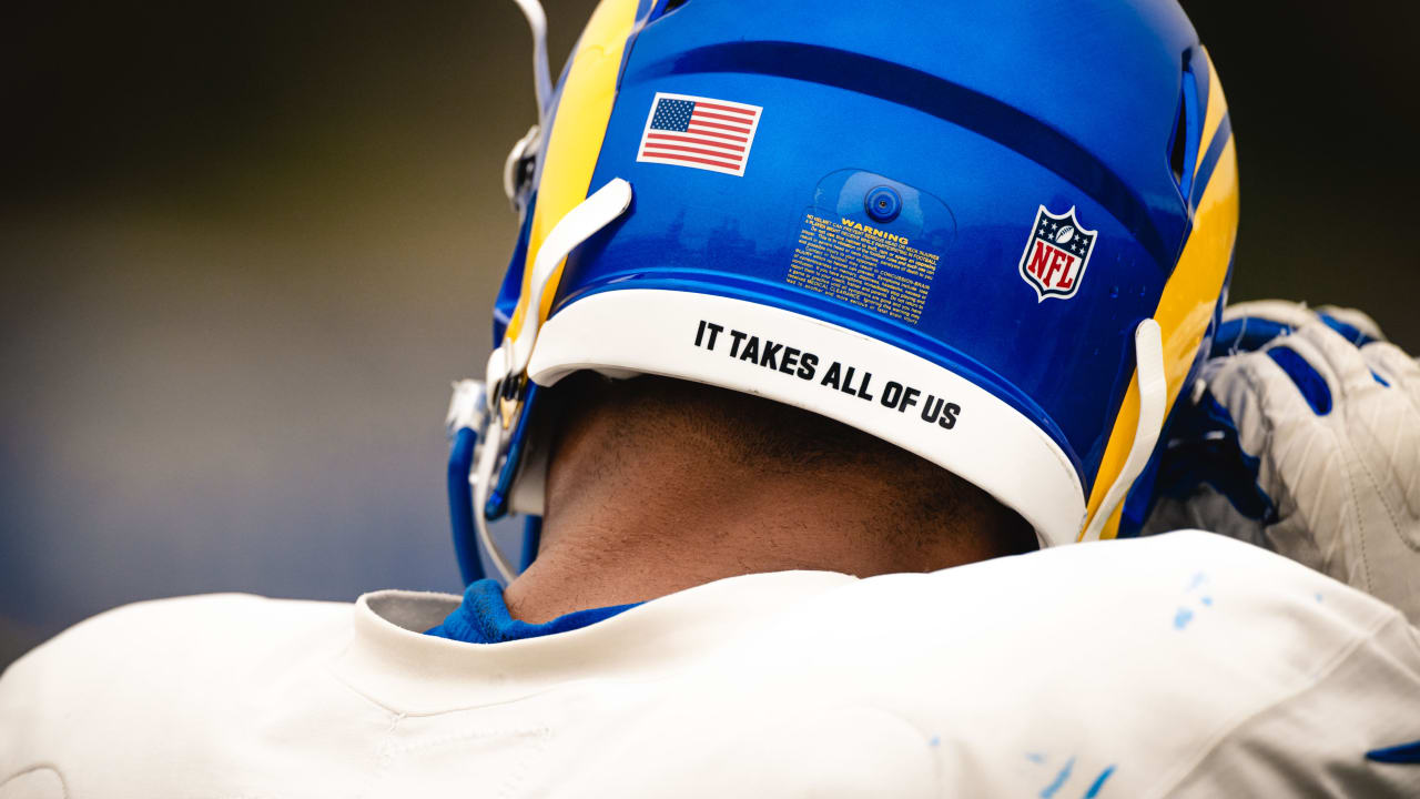 Why do NFL helmets have 'It Takes All of Us' written on them?