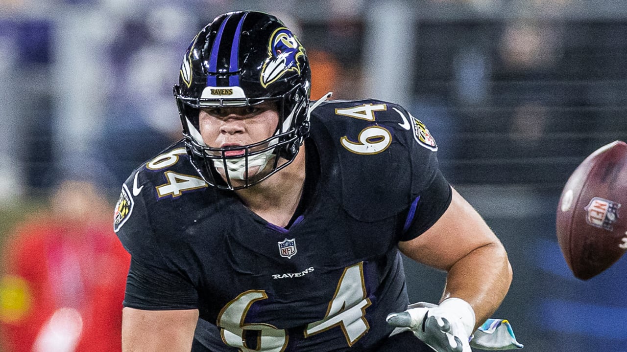 Baltimore Ravens center Tyler Linderbaum (64) signals during an