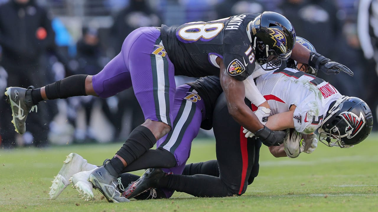 Joey Porter of the Miami Dolphins causes a fumble as the Baltimore