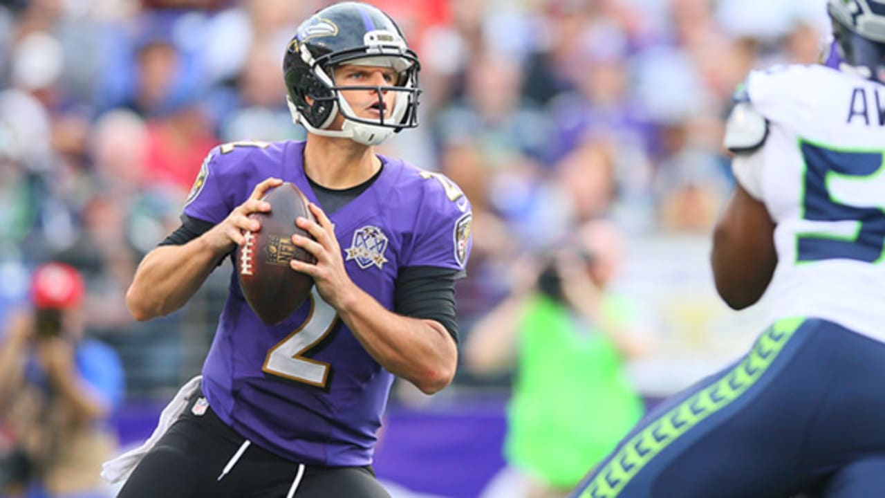 Baltimore Ravens' quarterback Jimmy Clausen passes under heavy