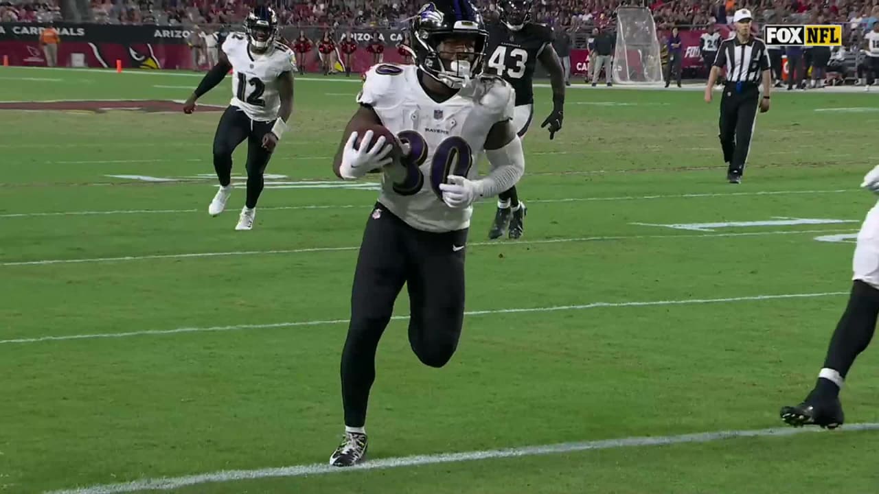 Running back (30) Tyler Badie of the Baltimore Ravens catches a pass and  runs for a touchdown against the Arizona Cardinals in an NFL preseason  football game, Sunday, Aug. 21, 2022, in