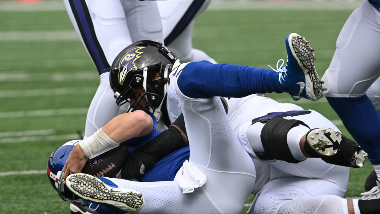 Baltimore Ravens defensive tackle Travis Jones (98) walks off the