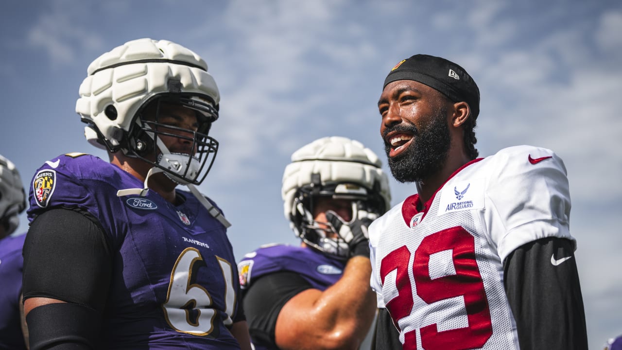 Kendall Fuller of the Washington Commanders prays with teammates