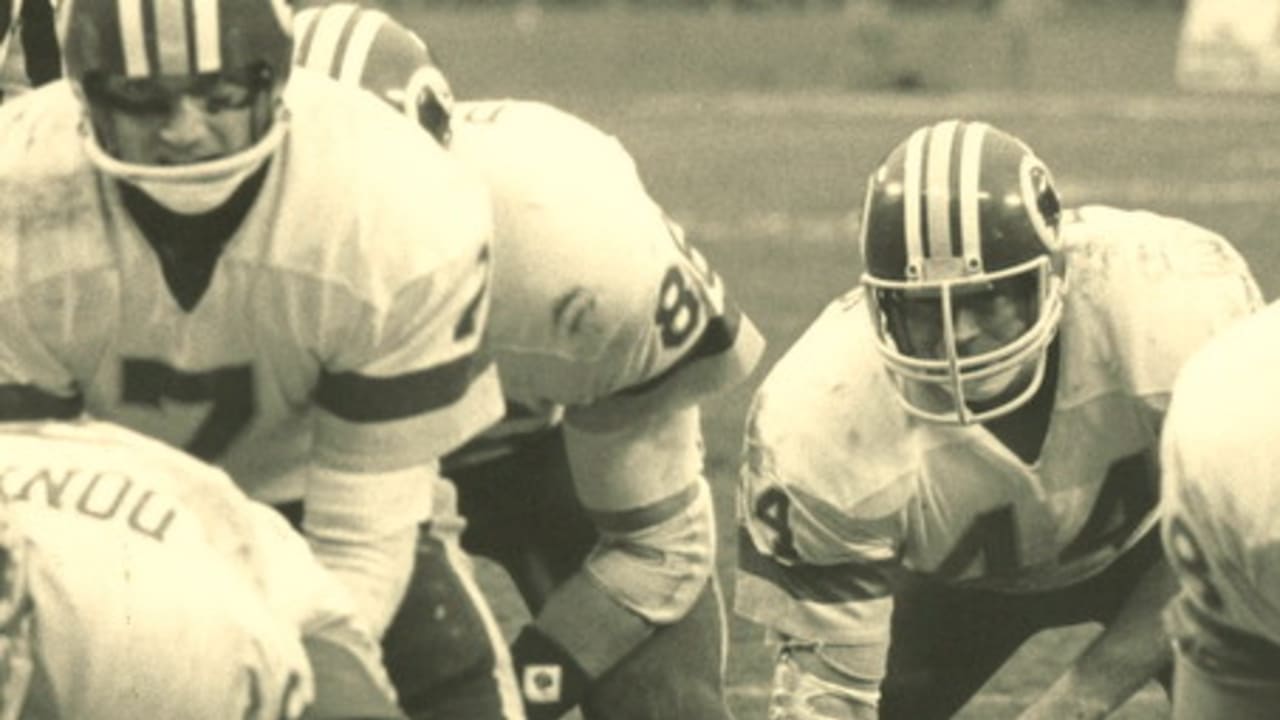 Washington Redskins' full back John Riggins (44) is slowed down