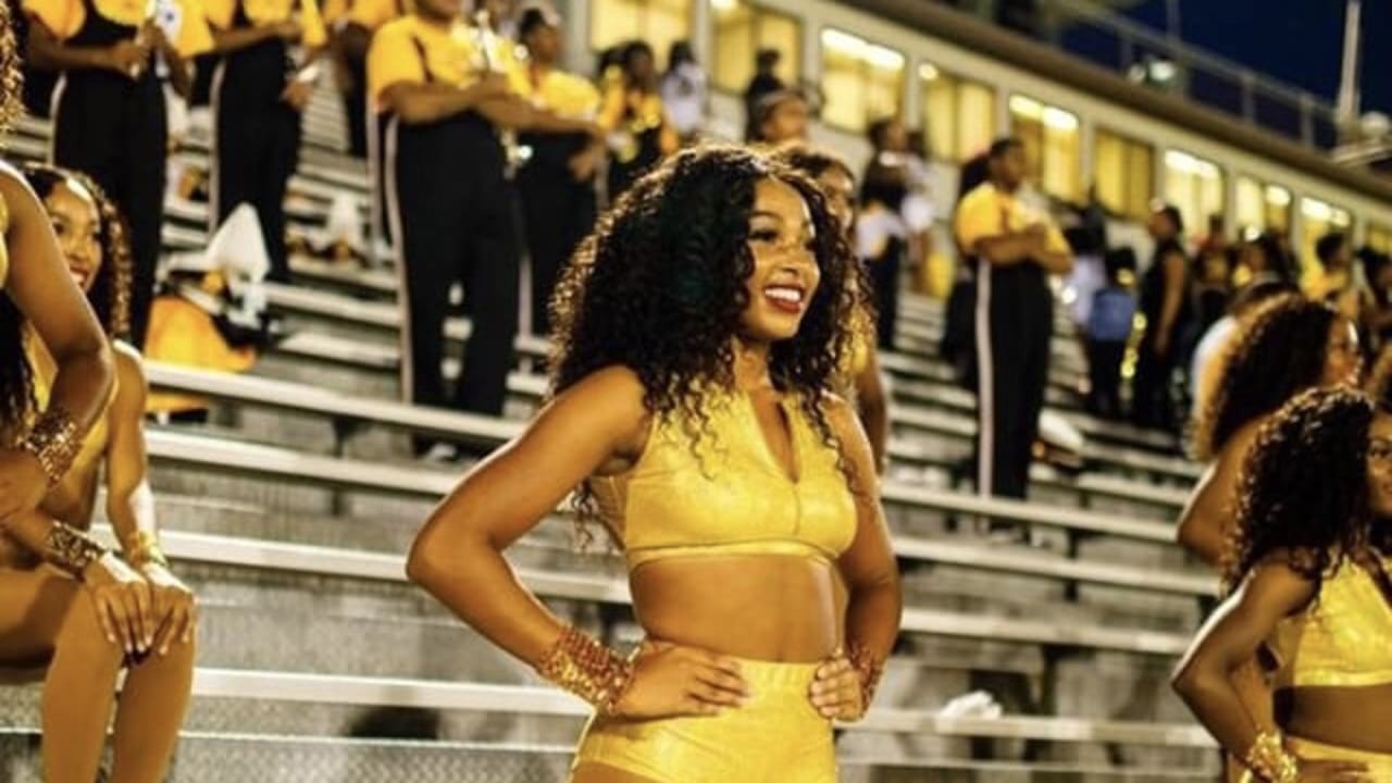 Miami Dolphins Cheerleader performs with her pom poms on the field