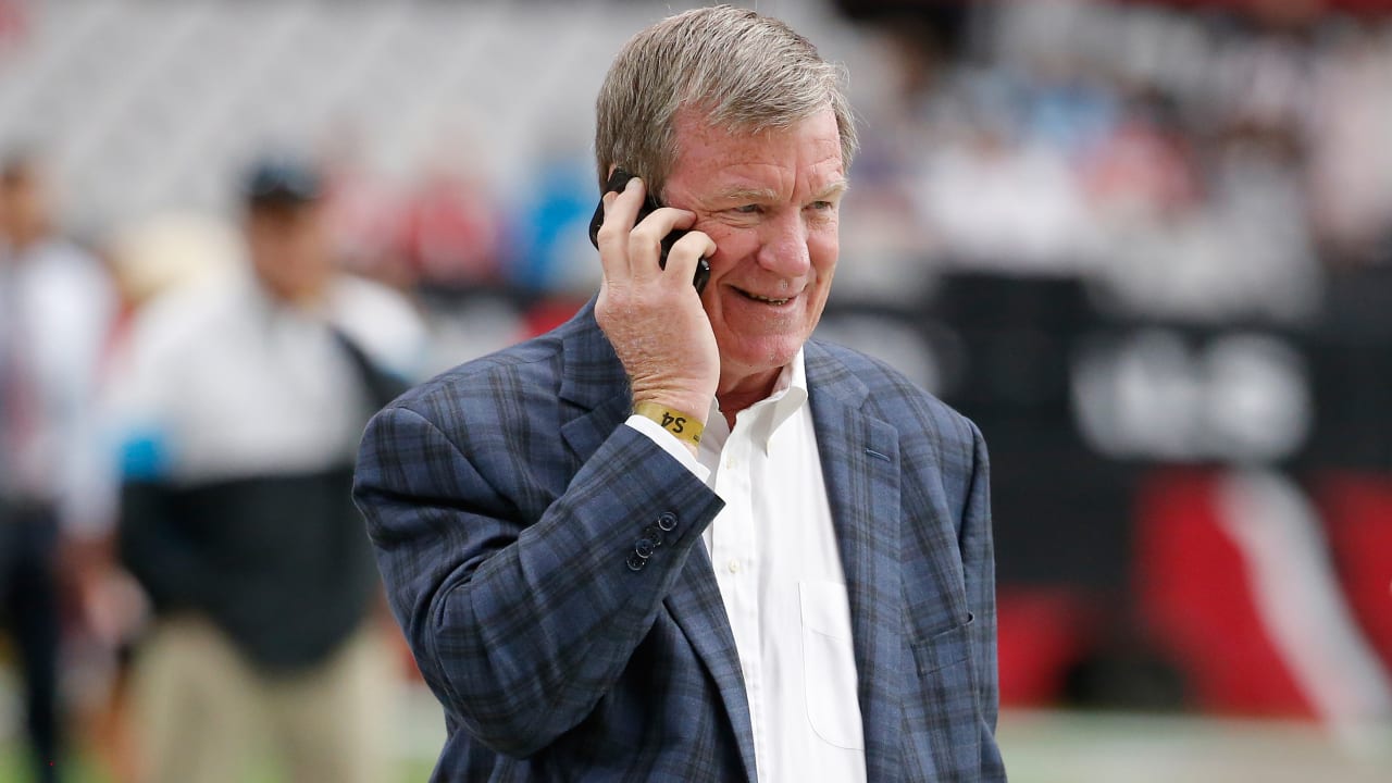 Carolina Panthers coach John Fox, left, helps draft choice Julius