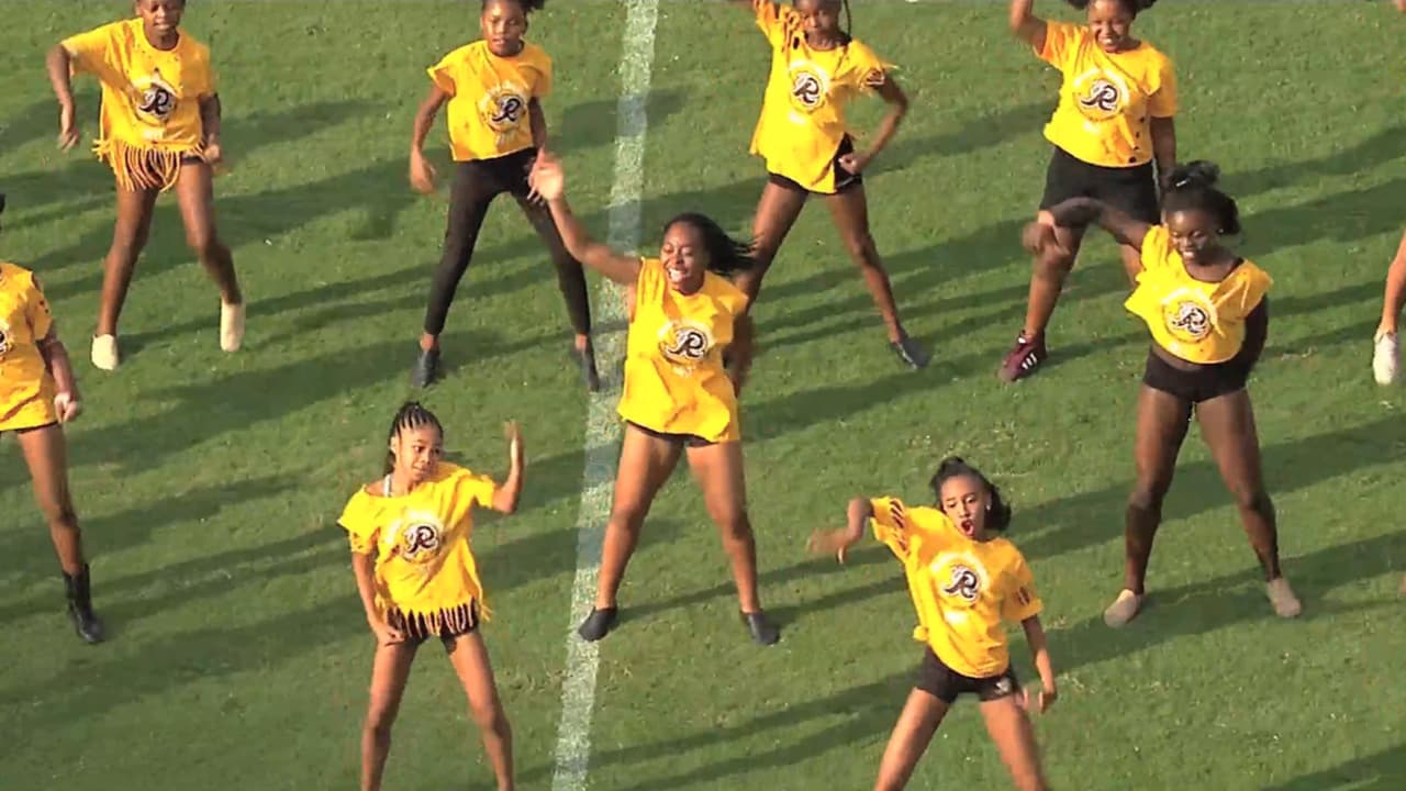 A Washington Commanders cheerleader performs during the second