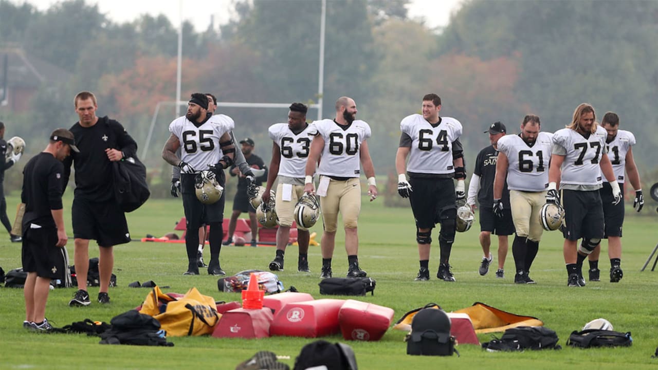 New Orleans Saints quarterback Drew Brees, left, and Zach Strief stand for  the U.S. national anthem before an NFL football game against the Miami  Dolphins at Wembley Stadium in London, Sunday Oct.