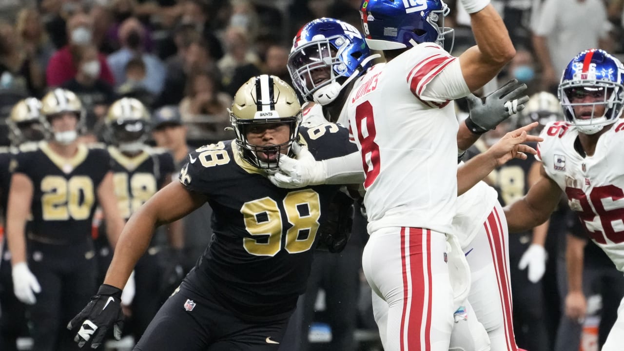 Washington Football Team quarterback Taylor Heinicke, left, rushes the ball  past New Orleans Saints defensive end Cameron Jordan in the first half of  an NFL football game, Sunday, Oct. 10, 2021, in