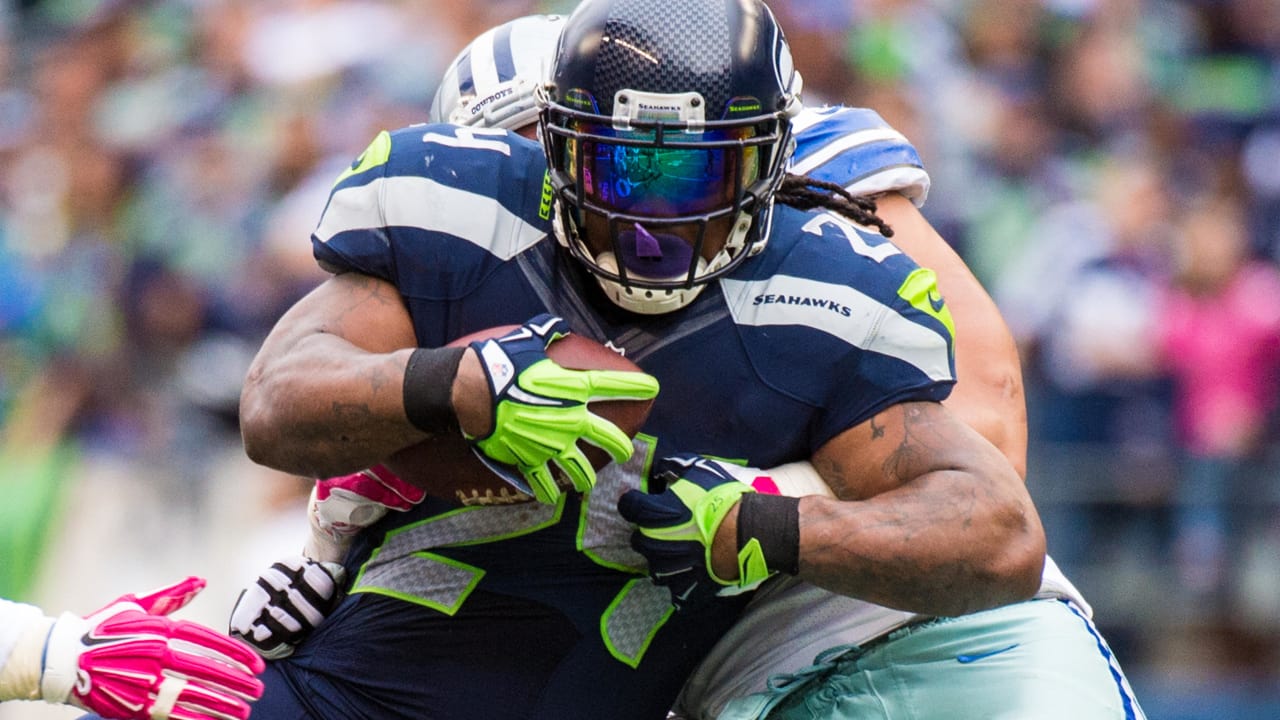 Seattle Seahawks running back Marshawn Lynch (24) looks over at Denver  Broncos free safety Mike Adams (20) after being tackled on his run during  the second quarter at the Super Bowl XLVIII