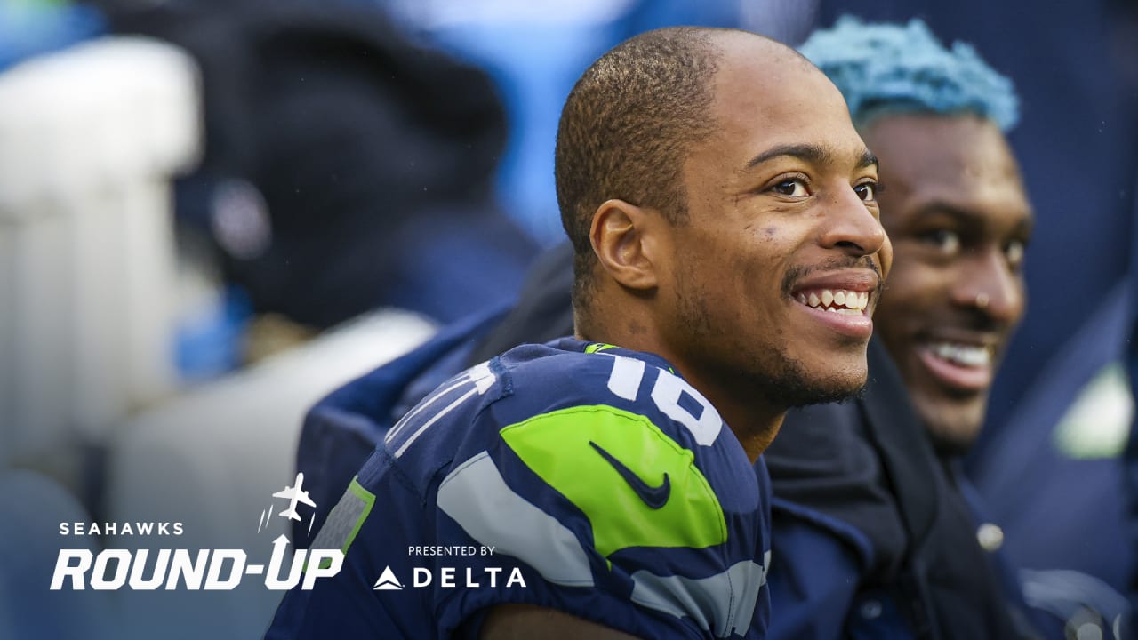 Wide receiver Tyler Lockett of the Seattle Seahawks smiles between