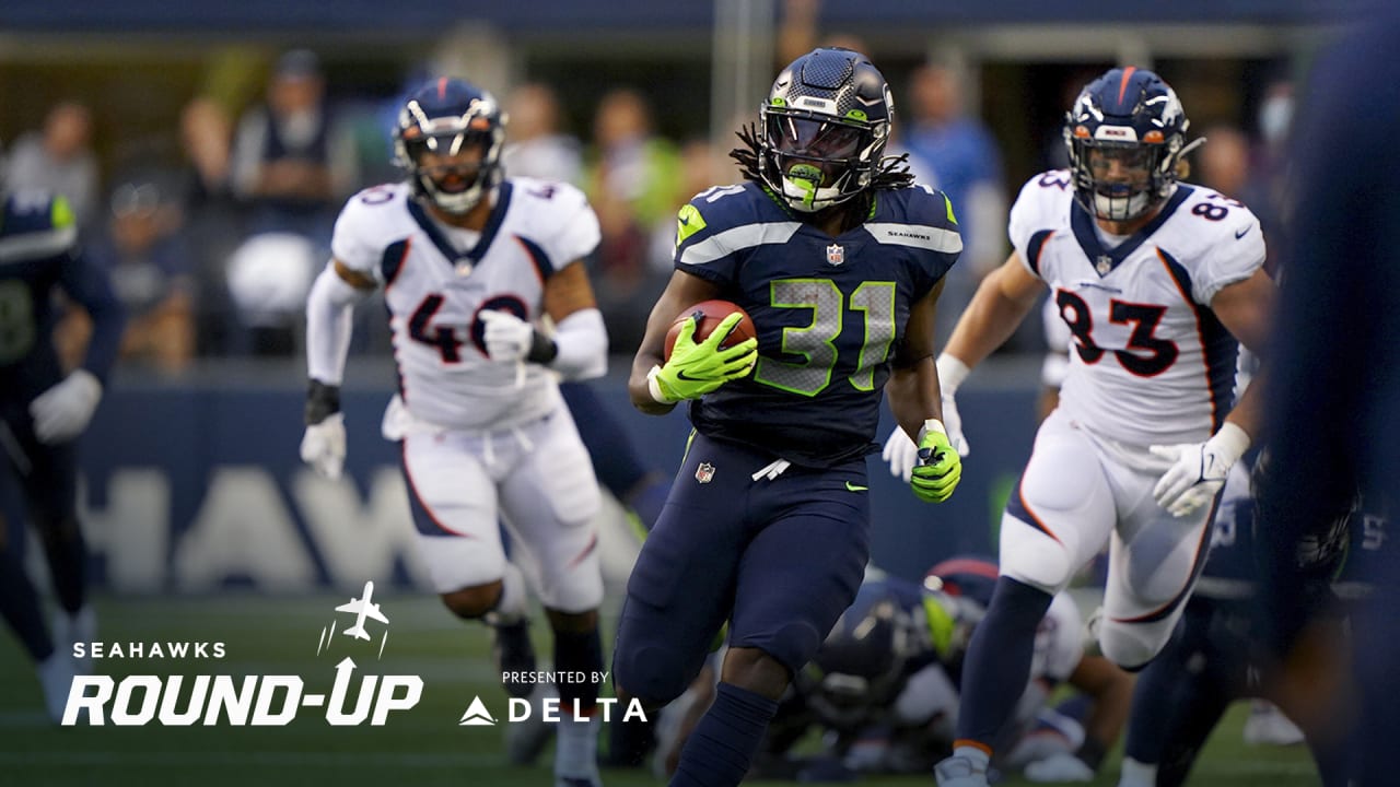 DeeJay Dallas of the Seattle Seahawks gestures to the fans during