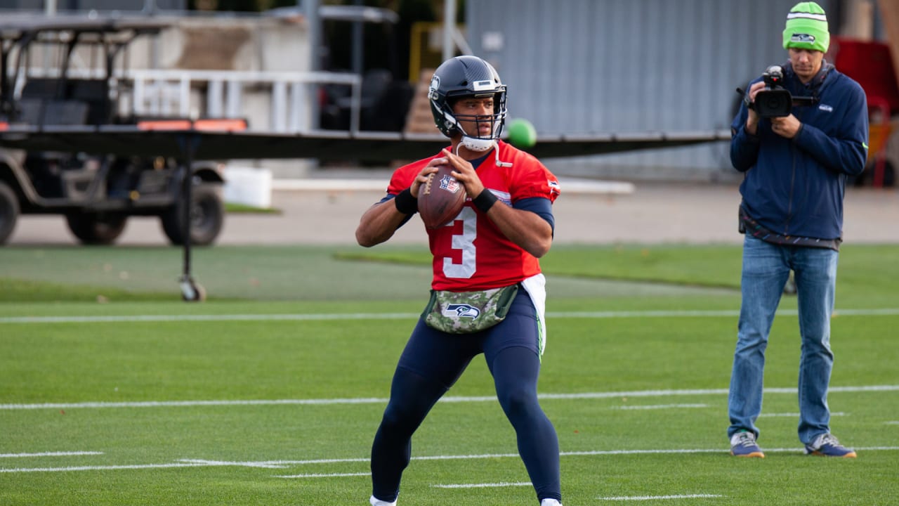 Seahawks QB Russell Wilson throws some passes with his left hand