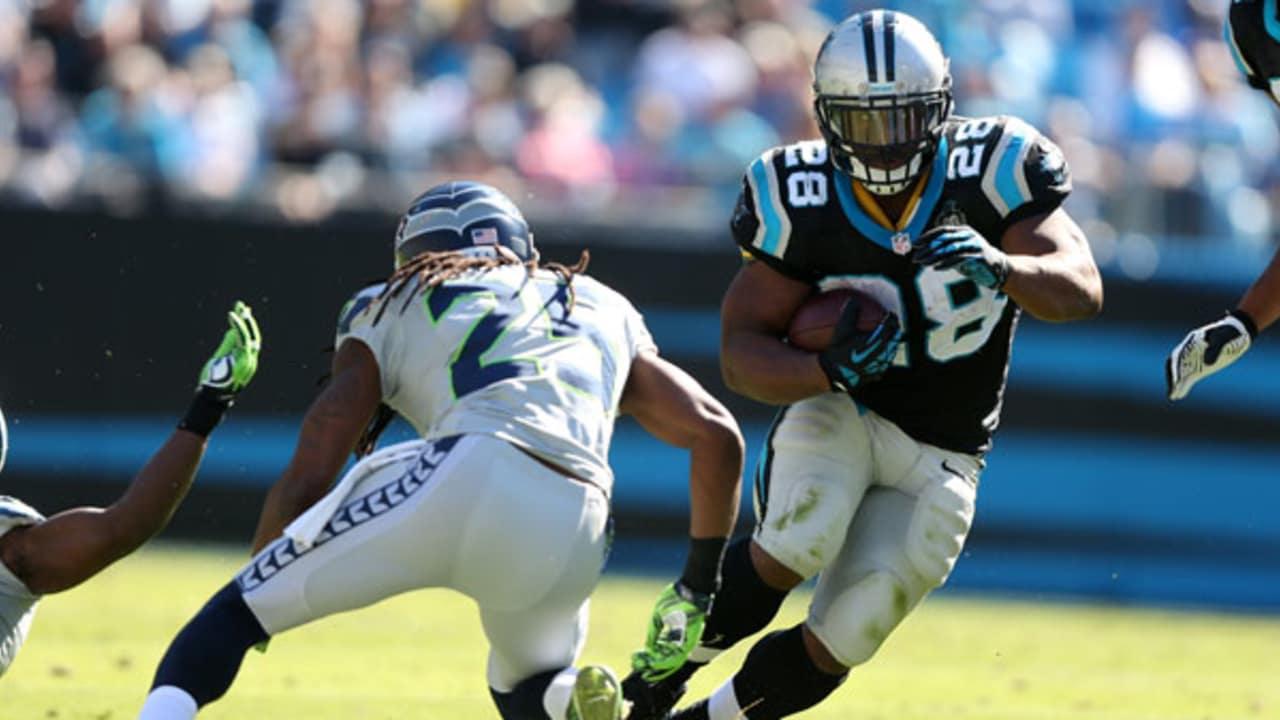 Carolina Panthers running back Jonathan Stewart, left, breaks free