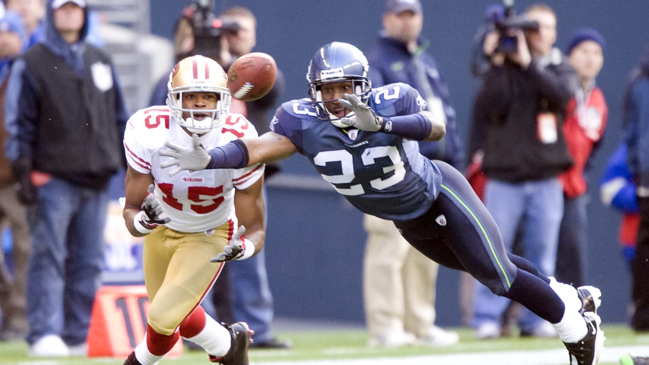 FILE - In this Jan. 5, 2008 file photo, Seattle Seahawks' Marcus Trufant  takes a last glance back as he returns an interception for a touchdown  against the Washington Redskins in an