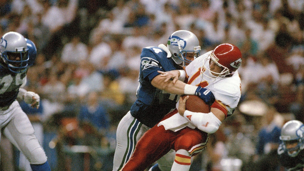 Seattle Seahawks - Seahawks quarterback Rick Mirer attempts to elude  Derrick Thomas during an NFL Football game against the Kansas City Chiefs  on January 2, 1994 in Kansas City, Missouri.