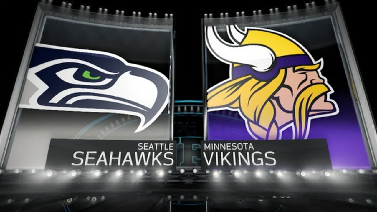 Seattle Seahawks vs. Minnesota Vikings. Fans support on NFL Game.  Silhouette of supporters, big screen with two rivals in background. Stock  Photo