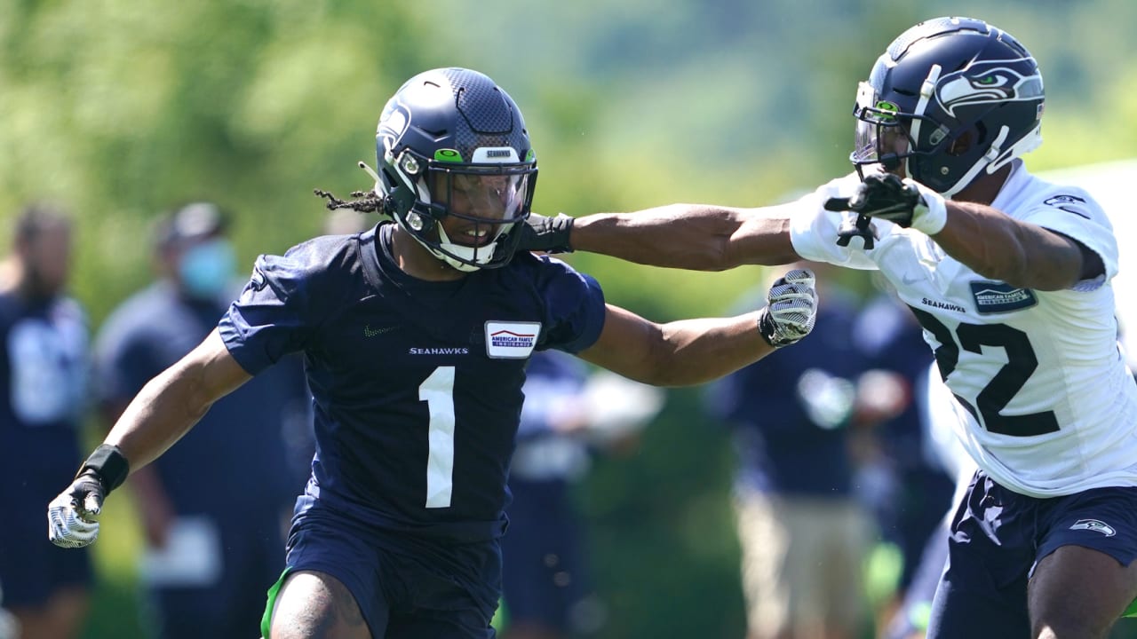 Seattle Seahawks wide receiver Dee Eskridge runs with a ball