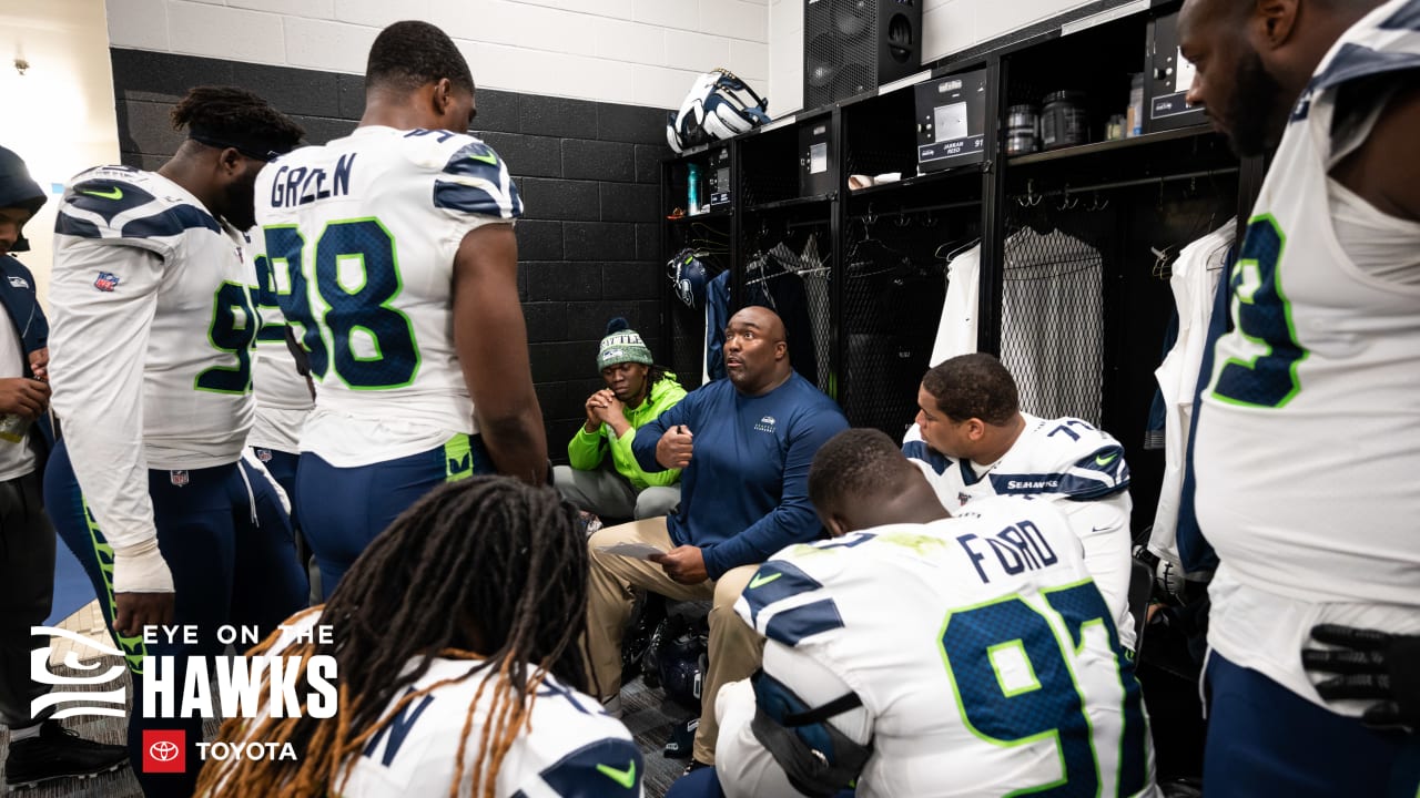 Seattle Seahawks quarterback Russell Wilson (3) hands pff to running back  Chris Carson (32) during the second half of an NFL football game against  the Carolina Panthers in Charlotte, N.C., Sunday, Dec.