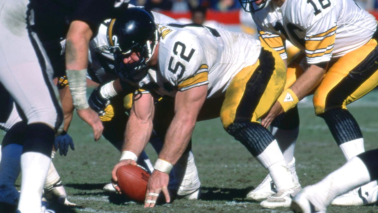 Steelers Mike Webster hiking the ball.