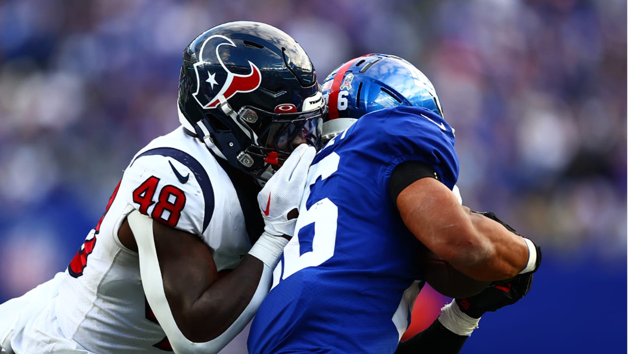 Houston Texans defensive end Adedayo Odeleye (75) helps up