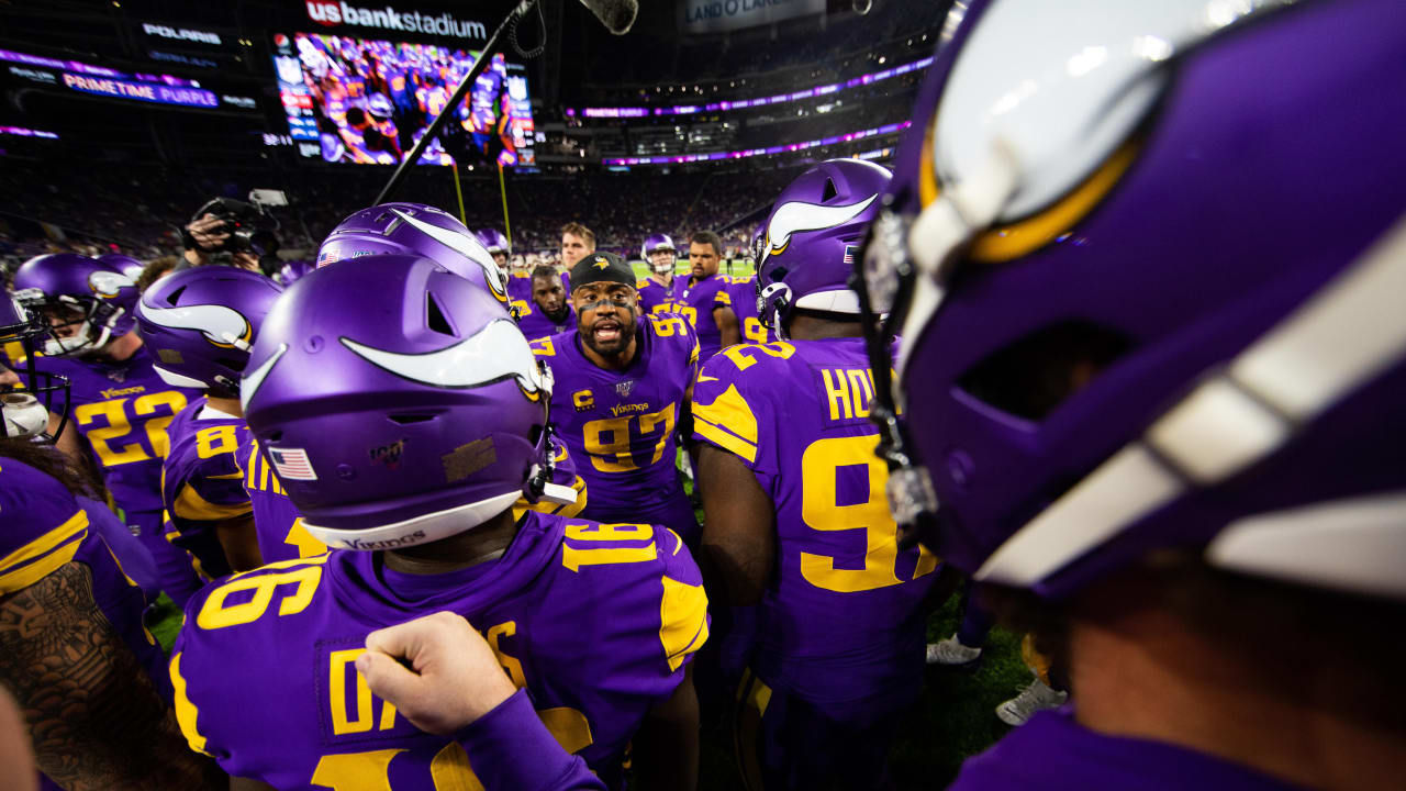 Minnesota Vikings players gathered on the field at U.S. Bank Stadium
